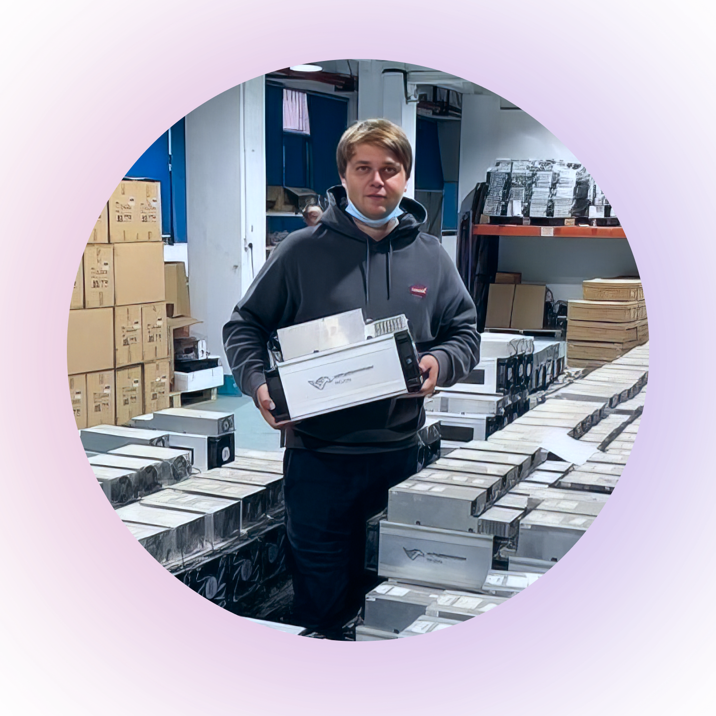 Person holding a box in a warehouse